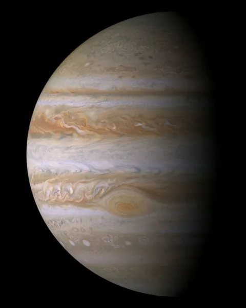 Jupiter's cloud tops form alternating light and dark bands, with the Great Red Spot embedded in one band.