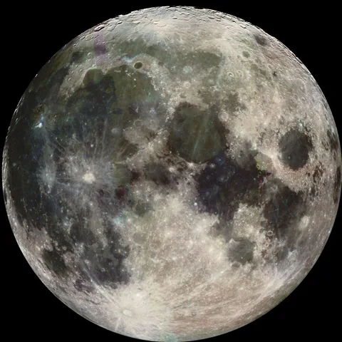 The round Moon has broad dark plains and bright rays spreading from the Tycho crater near the bottom.